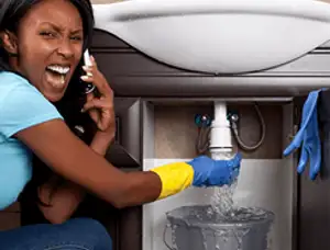 Emergency plumbing repair for a leaking sink drain under a bathroom vanity in Phoenix, AZ