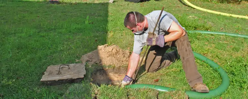 Septic pumping technician servicing a residential septic tank in Phoenix, AZ